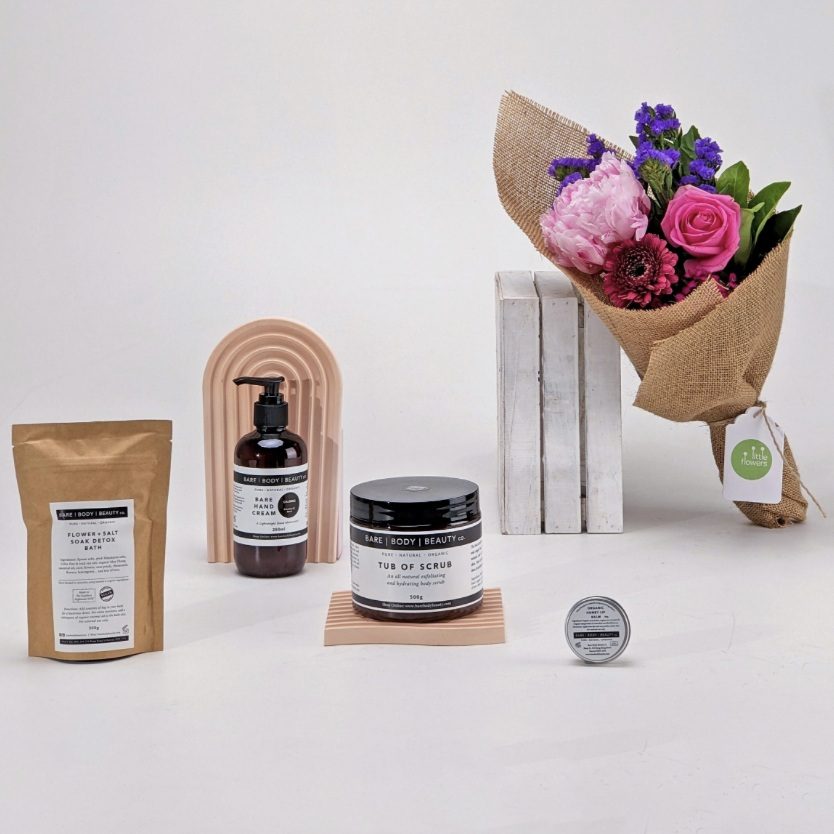 Gift pack with fresh flower bouquet, body exfoliator, bath soak, hand cream and lip balm. 